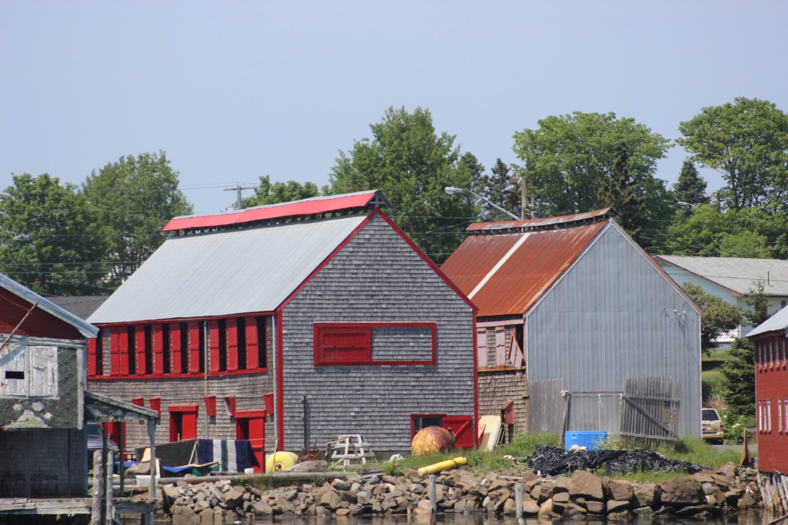 A red and white building next to a body of water.
