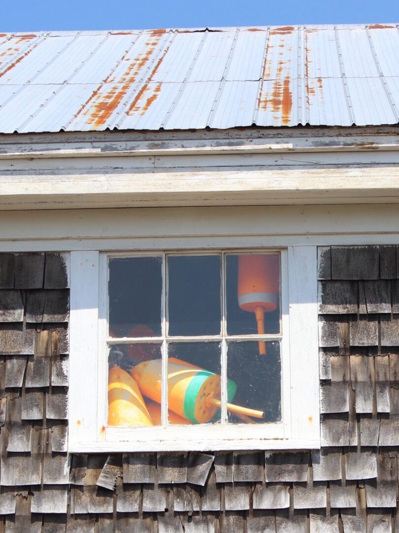 A window in a house with a bunch of buoys in it.