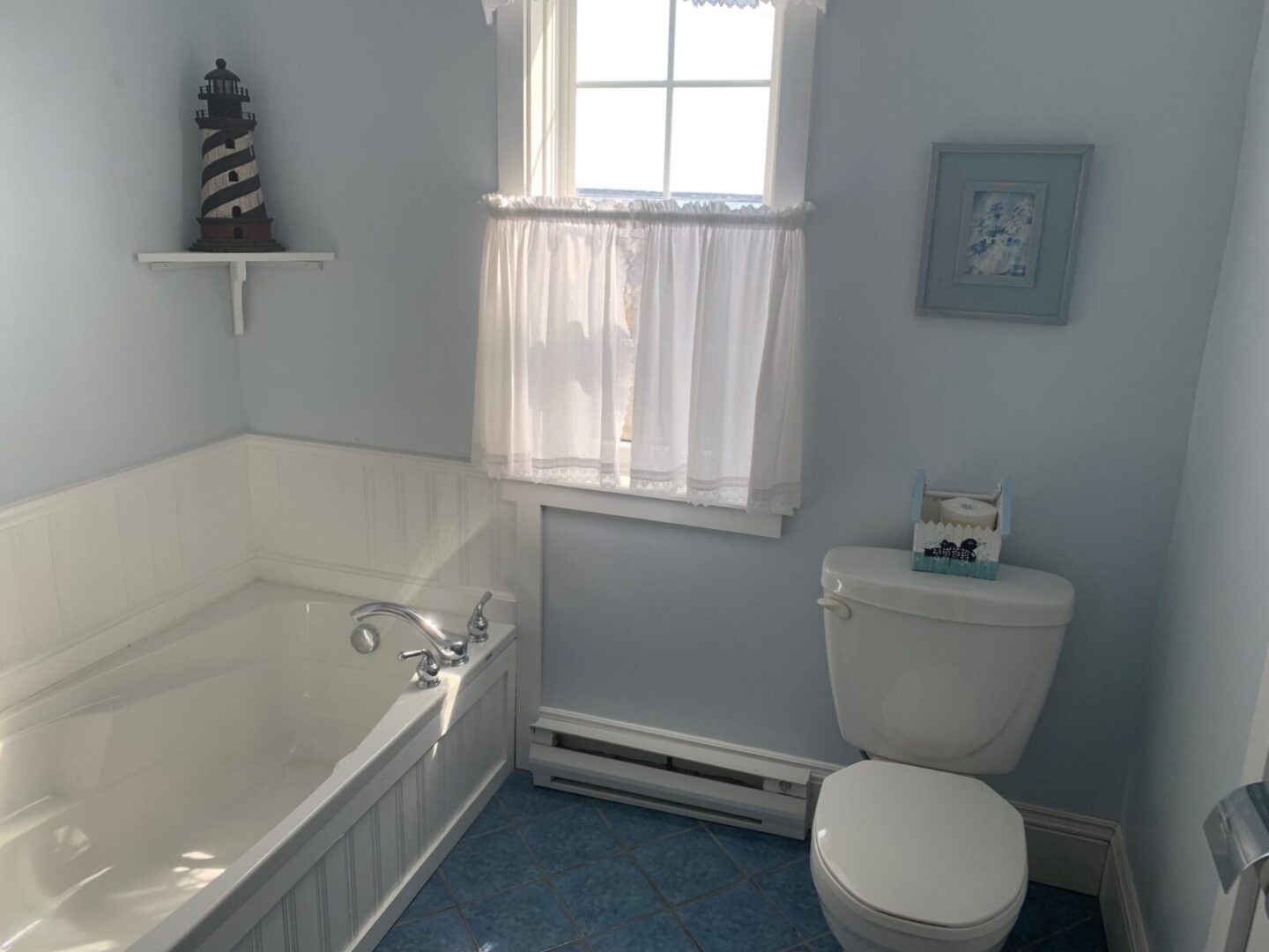 A bathroom with a toilet, sink, and tub.