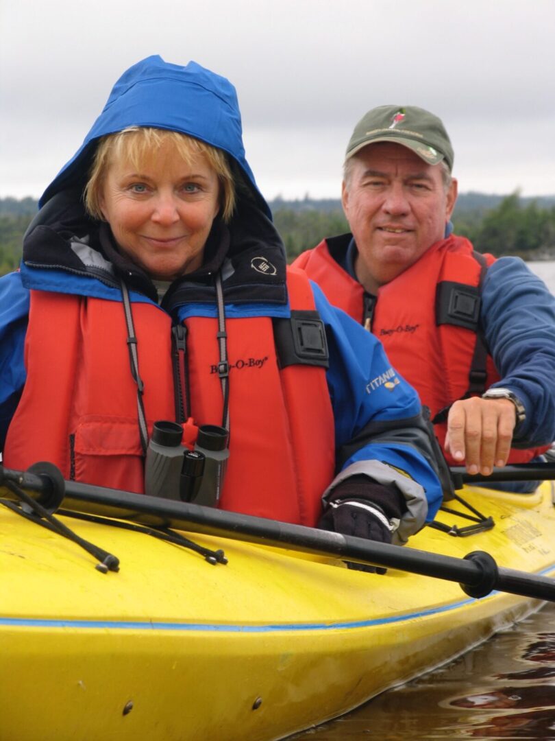 A man and woman in a yellow kayak.