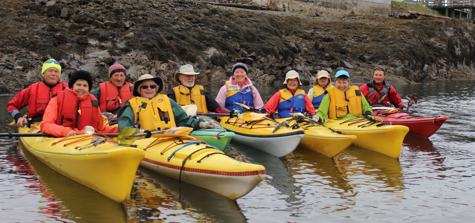 A group of people in yellow kayaks.