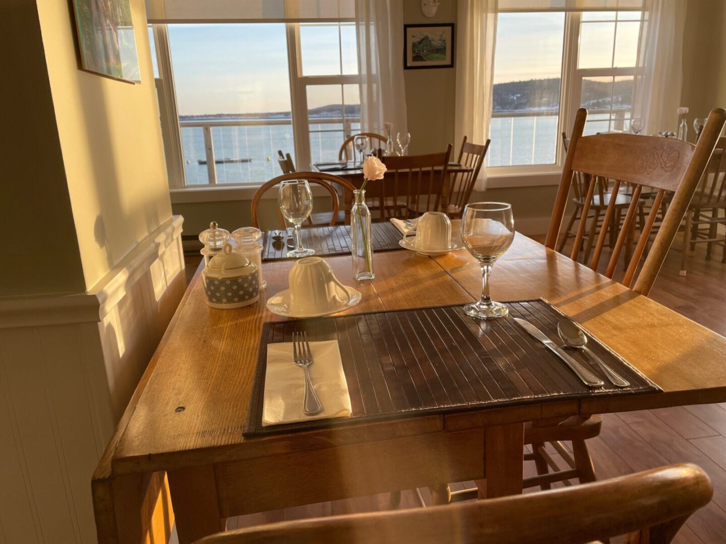 A dining room table with a view of the ocean.