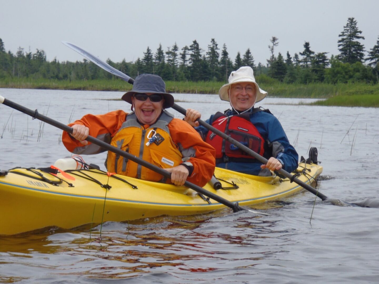 Two people in a yellow kayak.