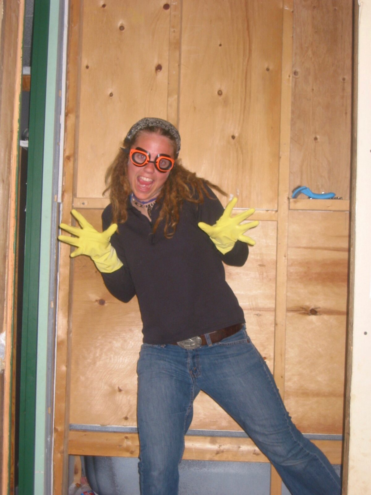 A woman wearing a pair of yellow gloves.