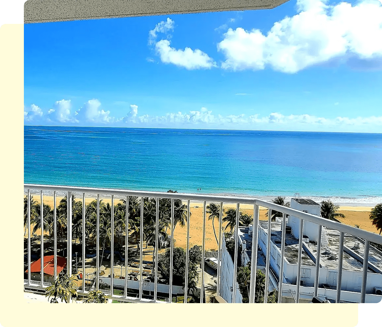Ocean view from a balcony, clear sky.