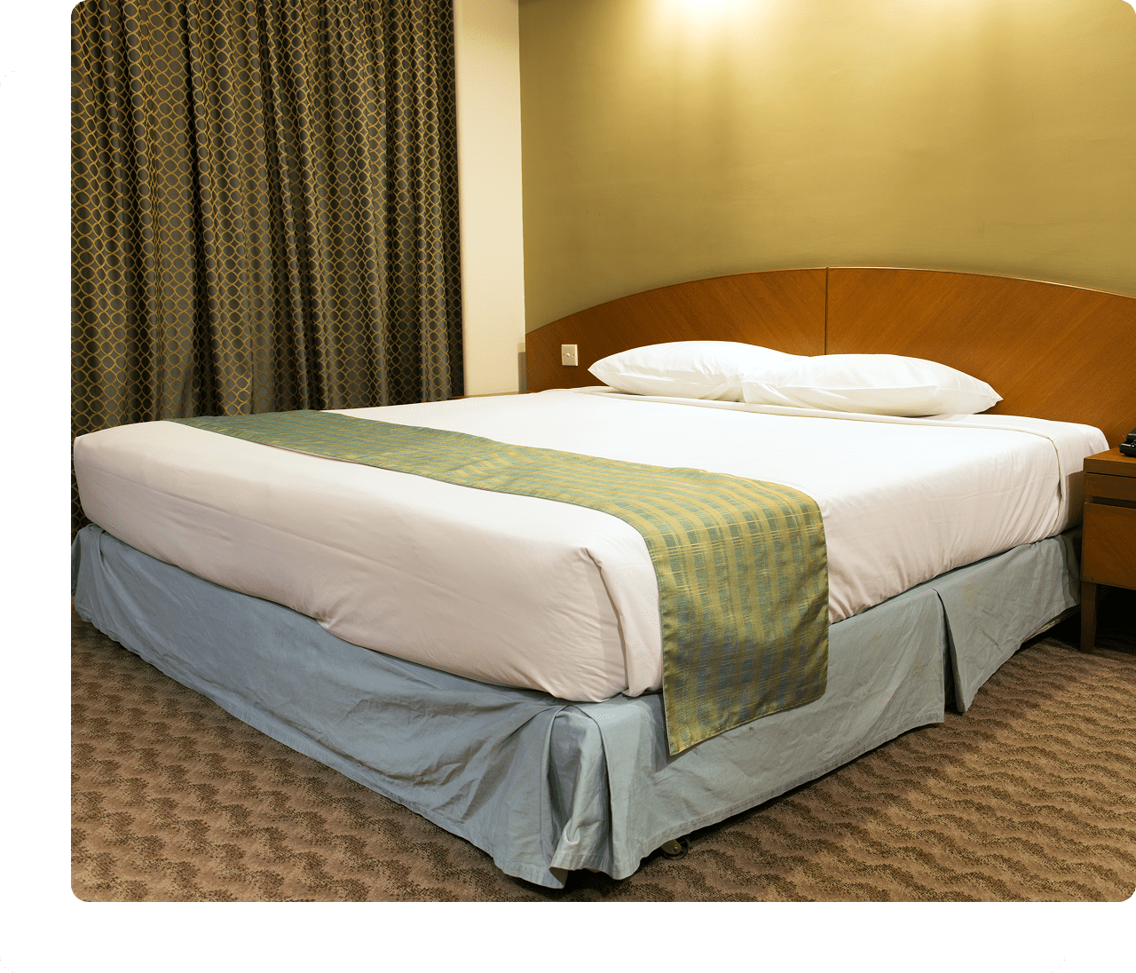 Hotel room with neatly made bed.