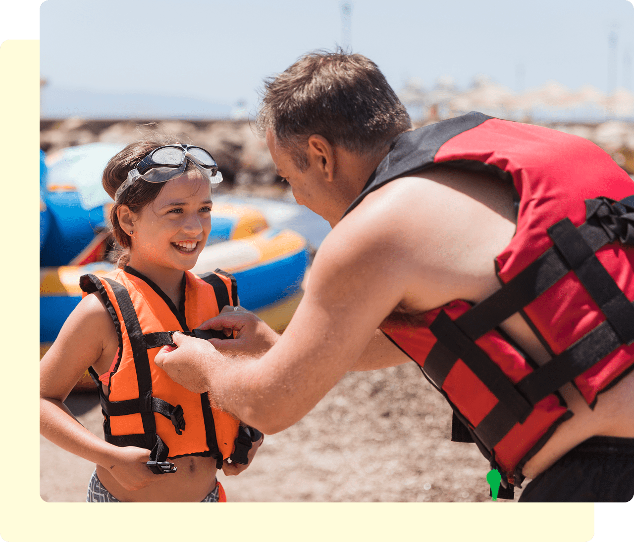 Man helping child with life jacket.