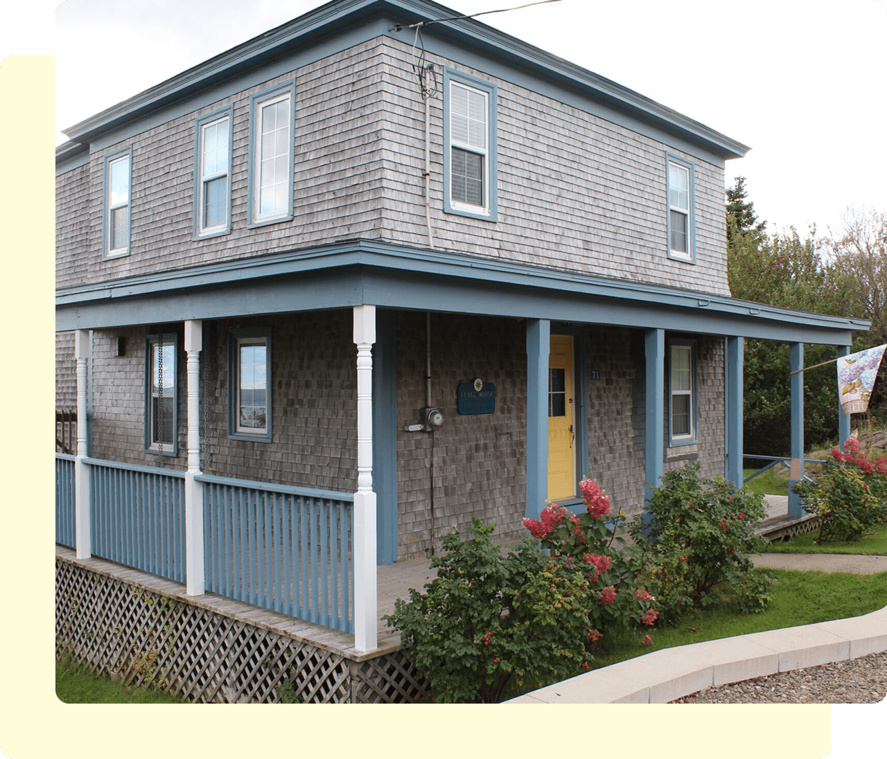 Two-story house with blue trim.