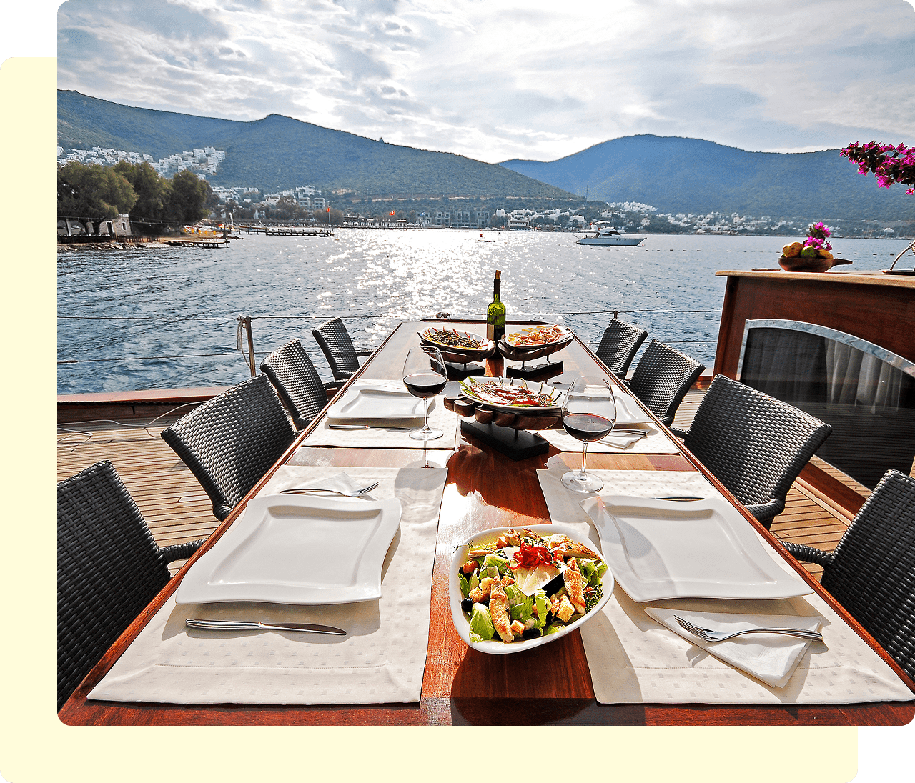Outdoor dining table with lake and mountain view.