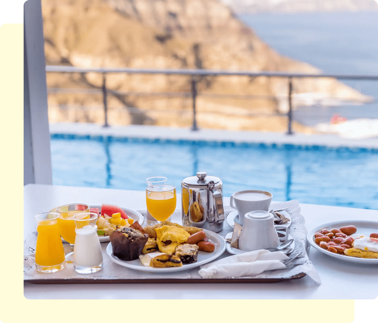 Breakfast by a pool with mountain view.