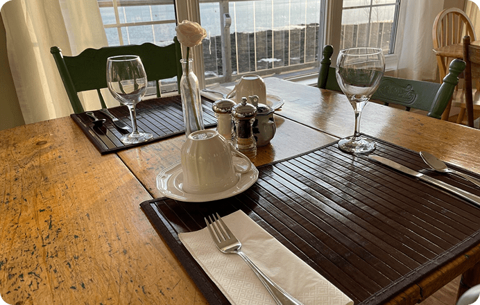 Table set for two by the window.
