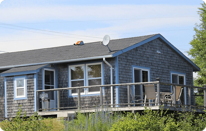 Rustic wooden cottage with a deck.