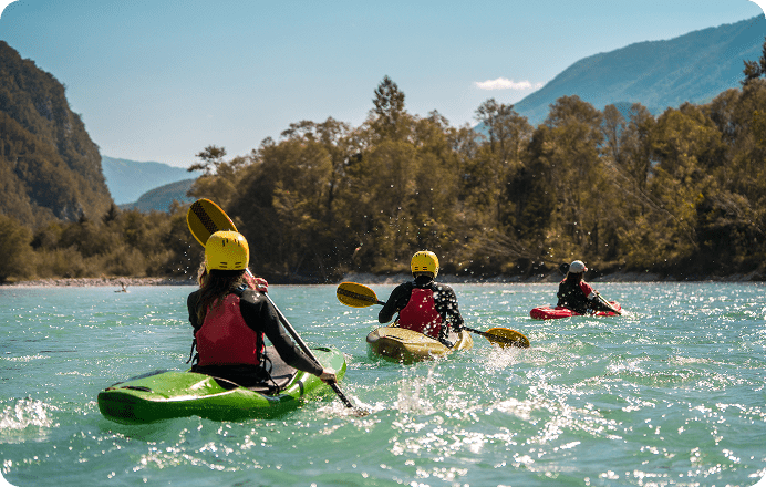 Kayakers paddling on a scenic river.