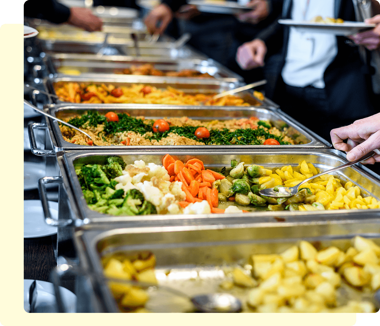 Buffet with various colorful dishes and vegetables.