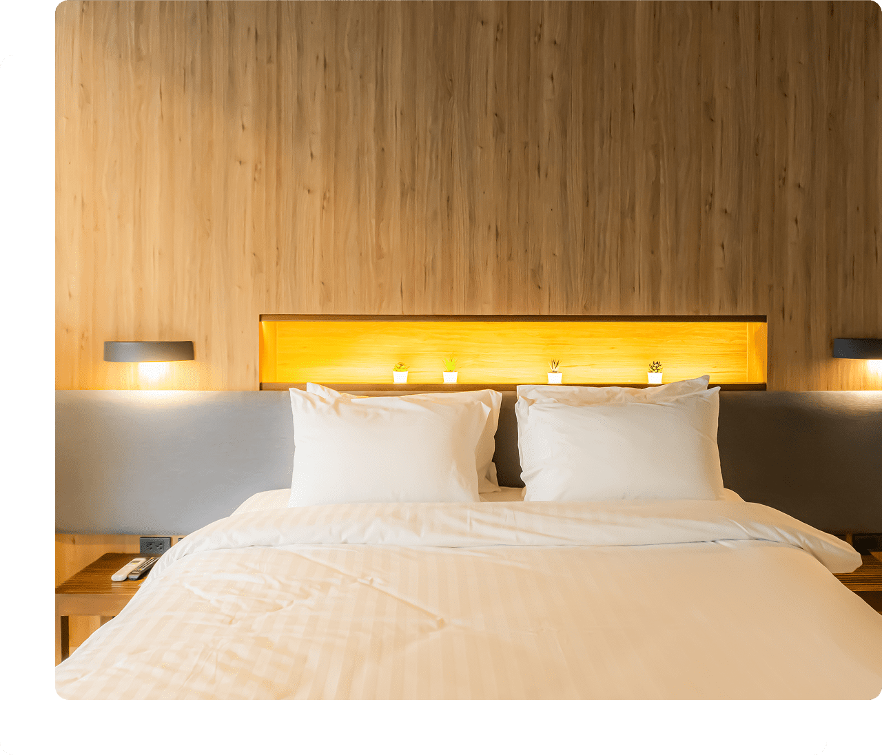 Hotel room with neatly made bed.