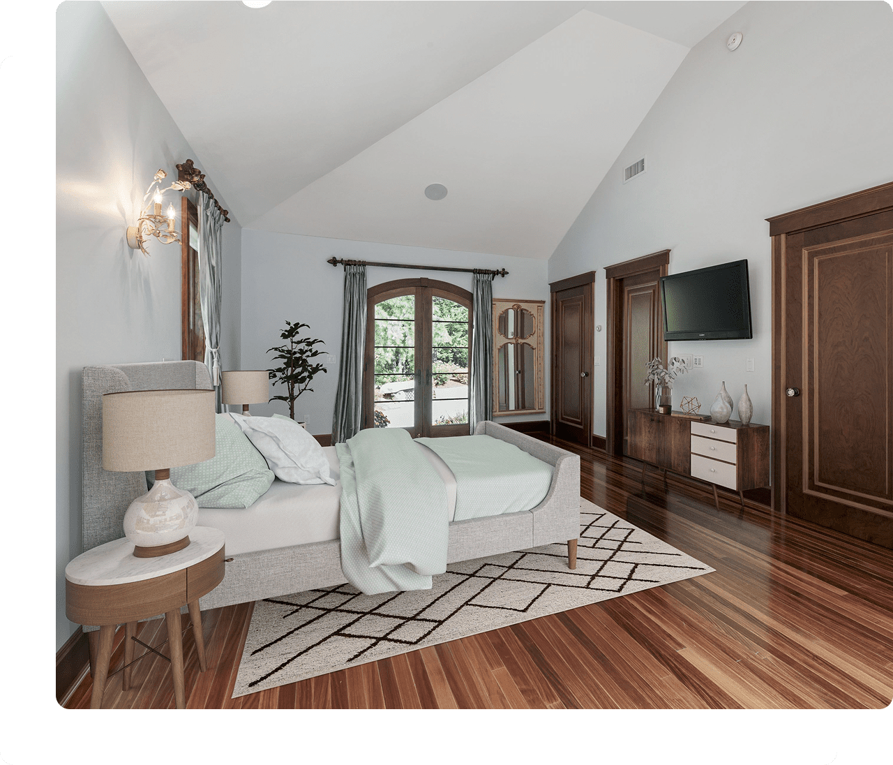 Modern bedroom with wooden floors and decor.