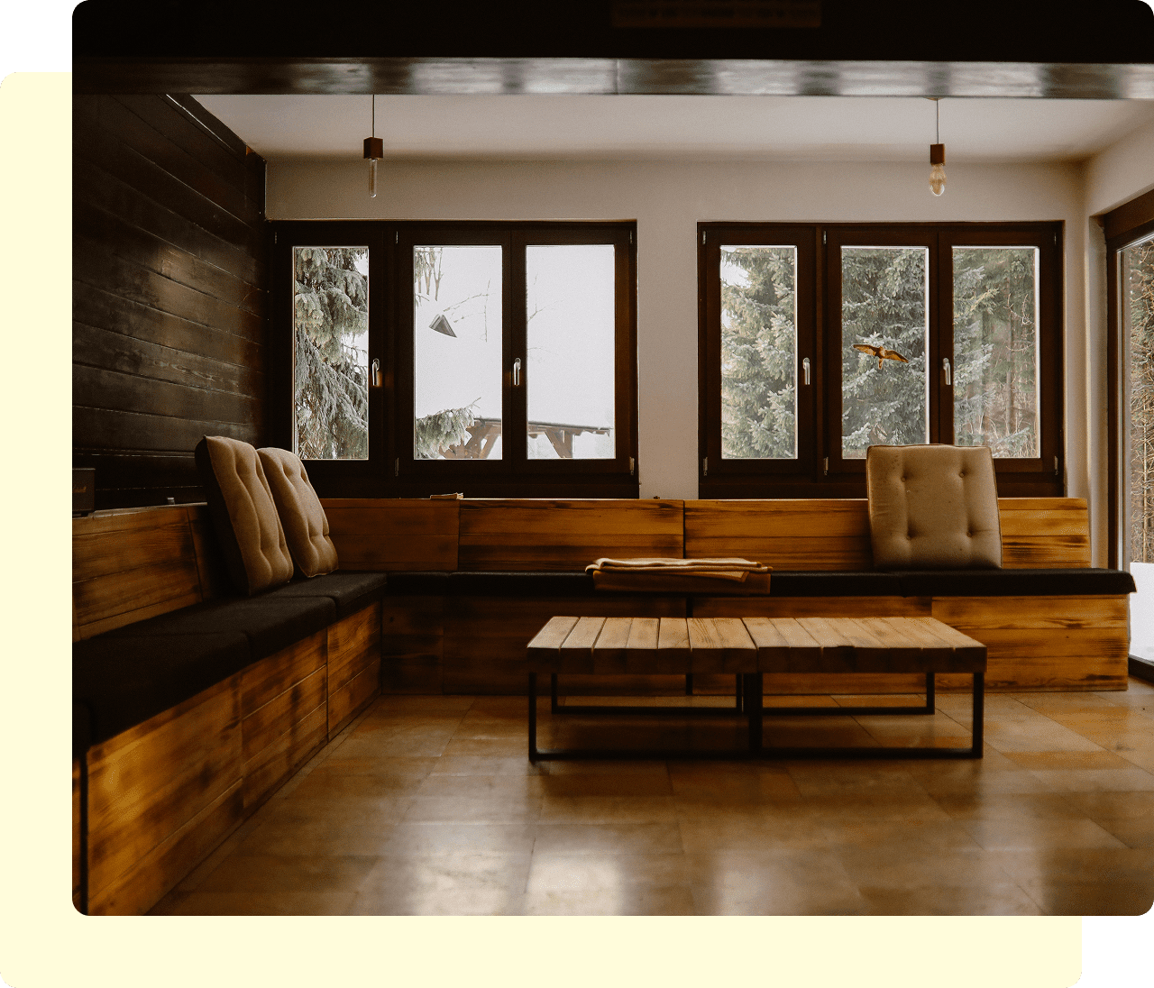 Cozy wooden living room with large windows.