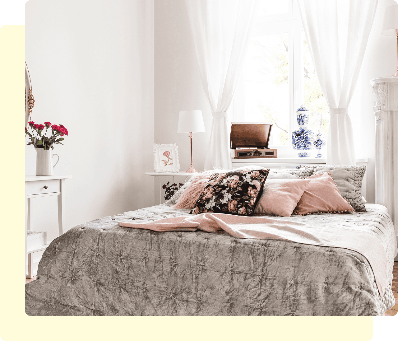 Cozy bedroom with pillows and natural light.
