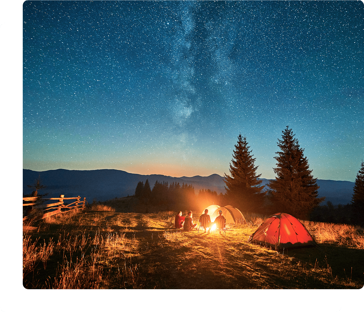 Tents and campfire under starry Milky Way
