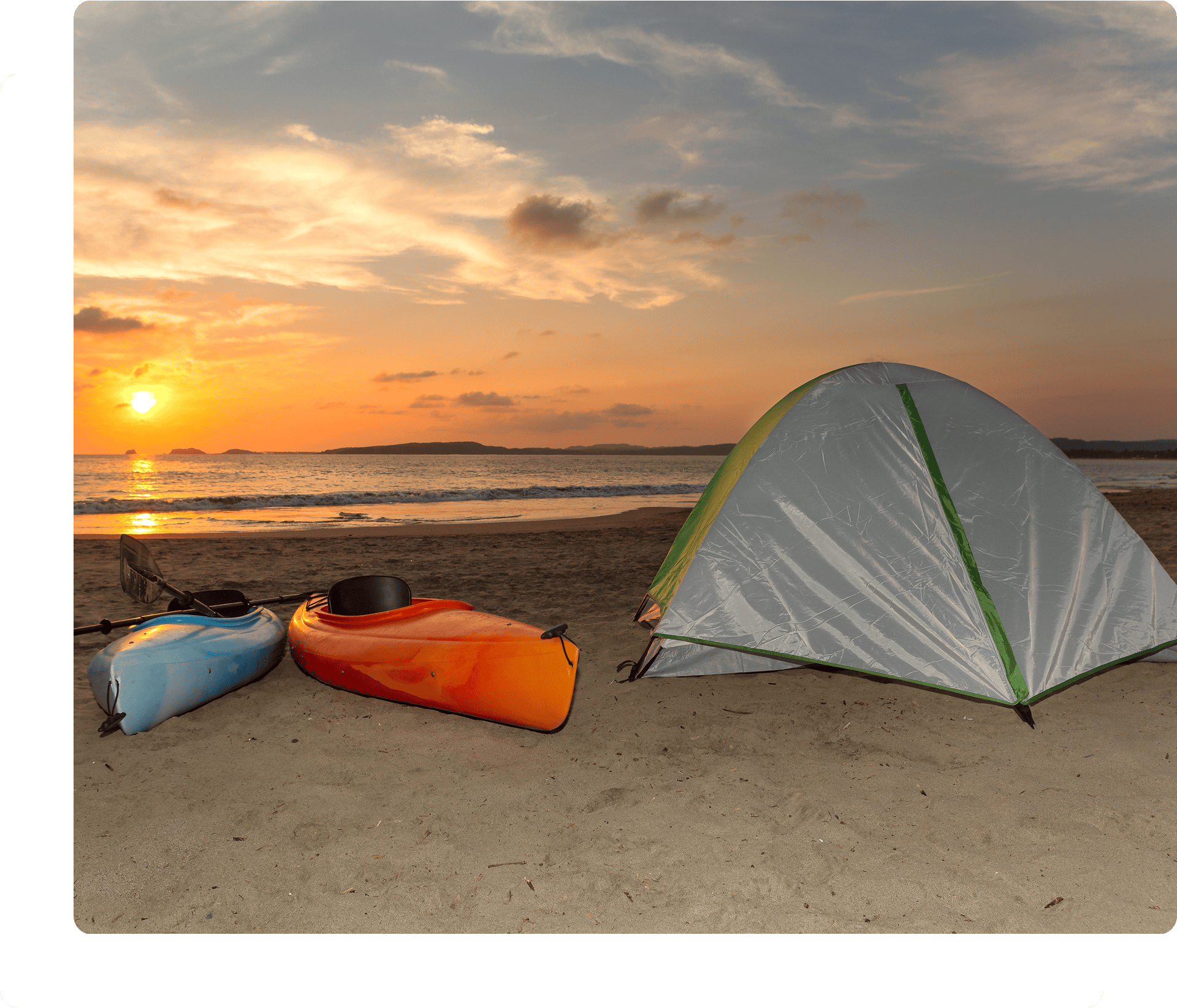 Beach sunset with kayaks and tent.