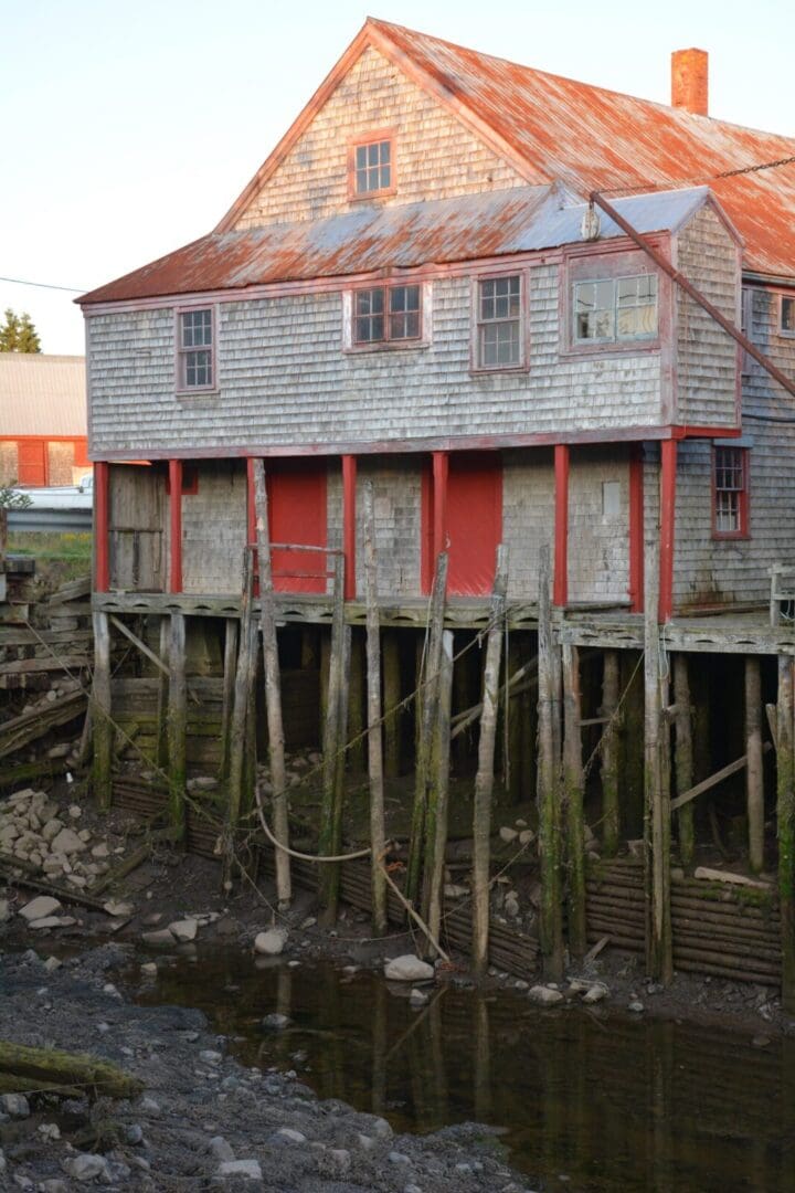 Weathered seaside structure with wooden supports