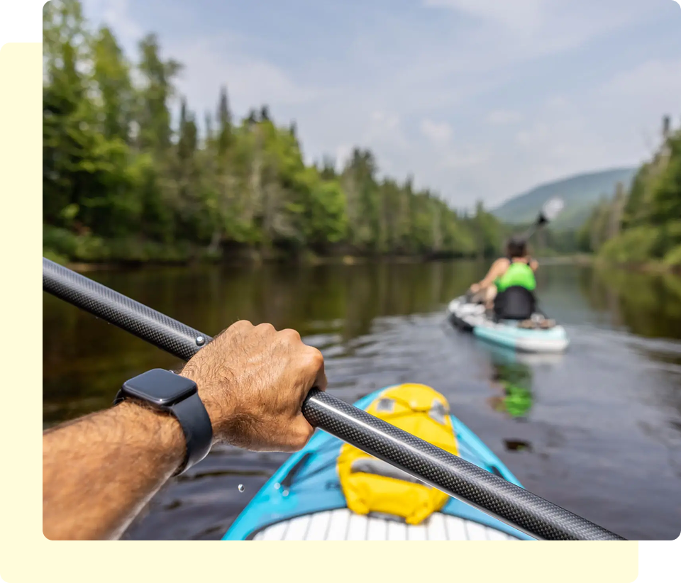 Kayaking on a calm forested river.