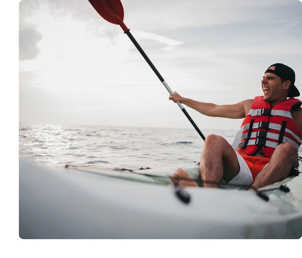 Man kayaking energetically on open water.