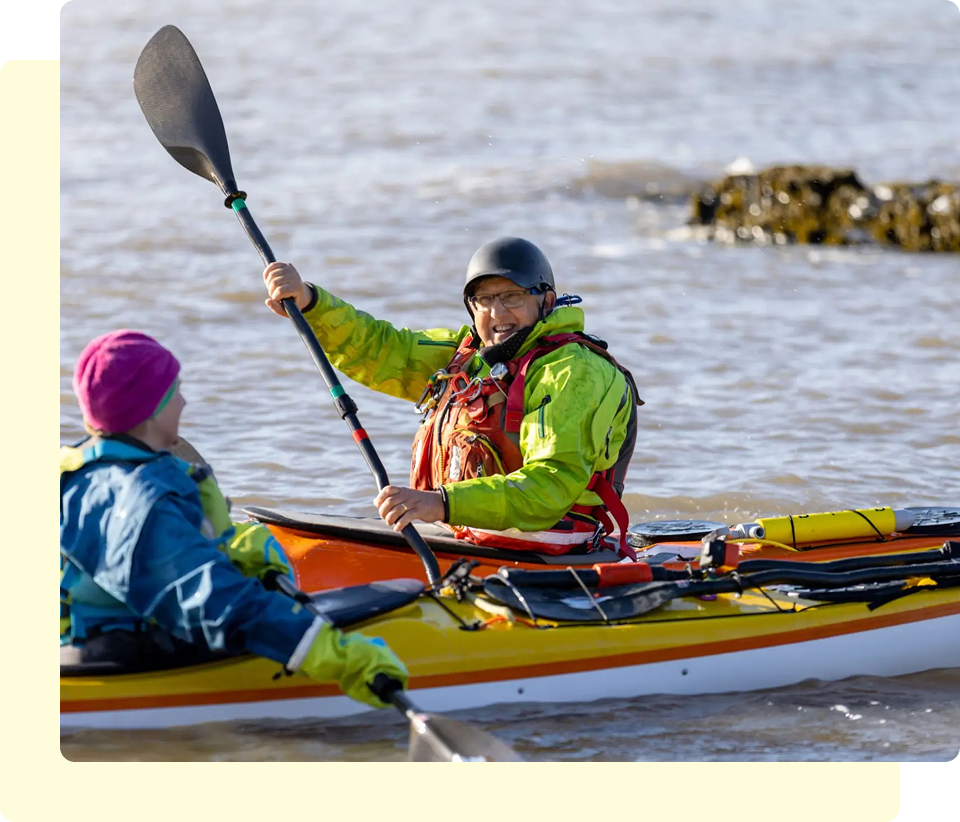 Two people kayaking on a sunny day.