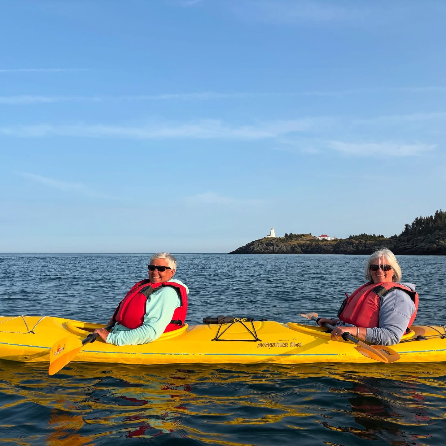 Two people kayaking on calm water