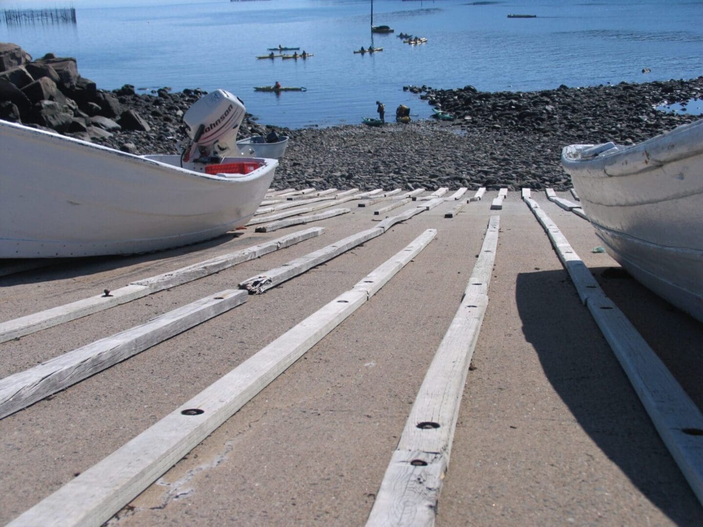 Boats resting on wooden slipway tracks