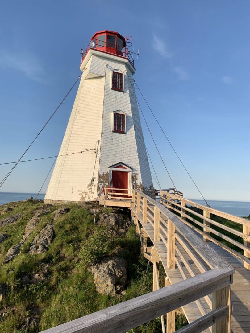White lighthouse with red accents and walkway