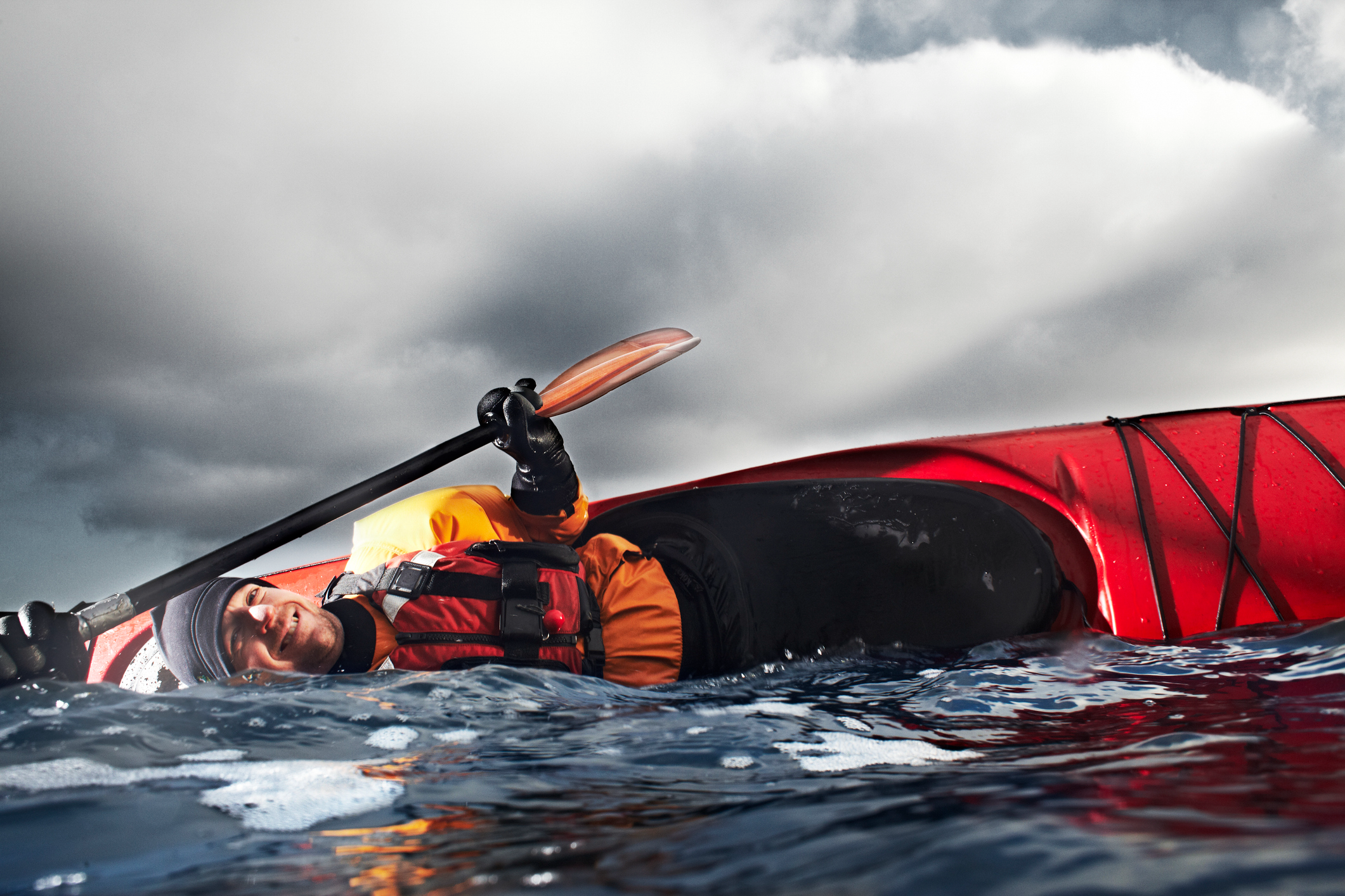 Red kayak in turbulent sea