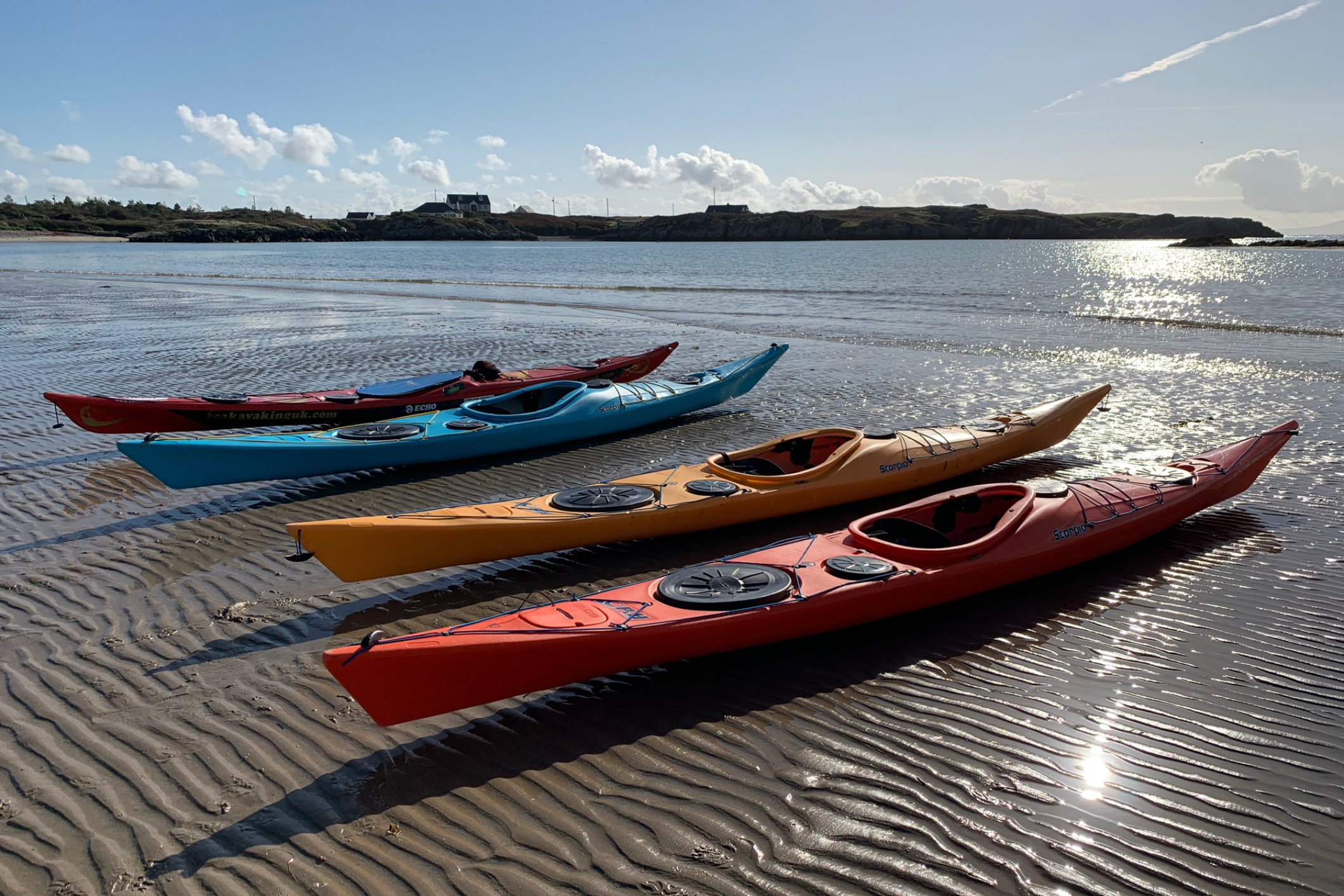 Colorful kayaks on a sandy beach