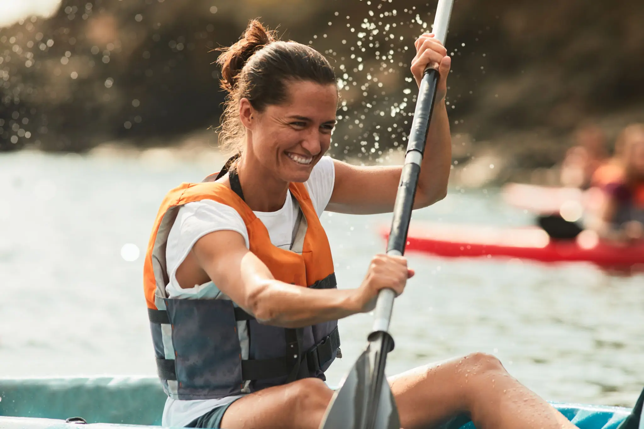 Woman kayaking on a sunny day.